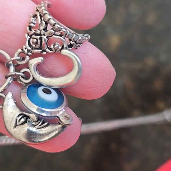 A charm necklace with a moon, a sea in evili, and a crown on in 18-20inc chain - Picture 2 of 3